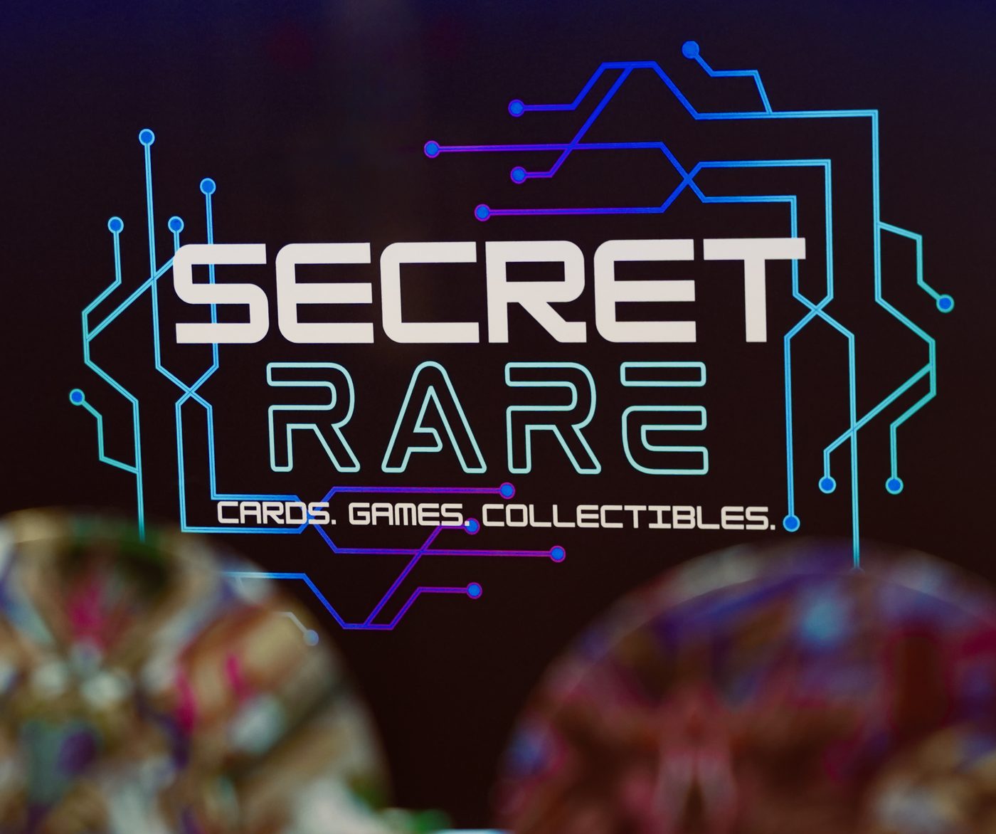 The Secret Rare circuit-board logo: Cards. Games. Collectibles.