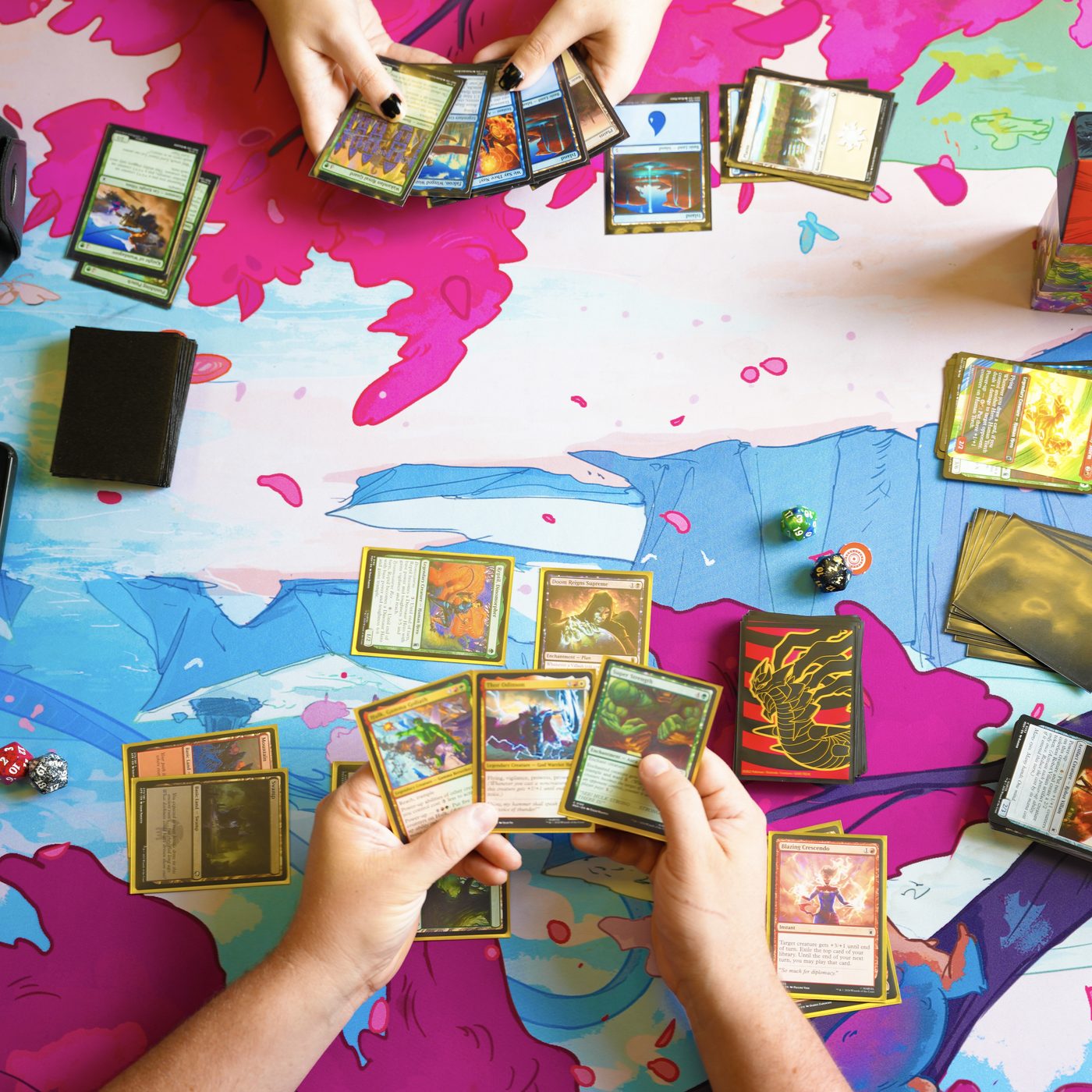 An overhead view of a Magic: The Gathering game in progress on a colorful playmat